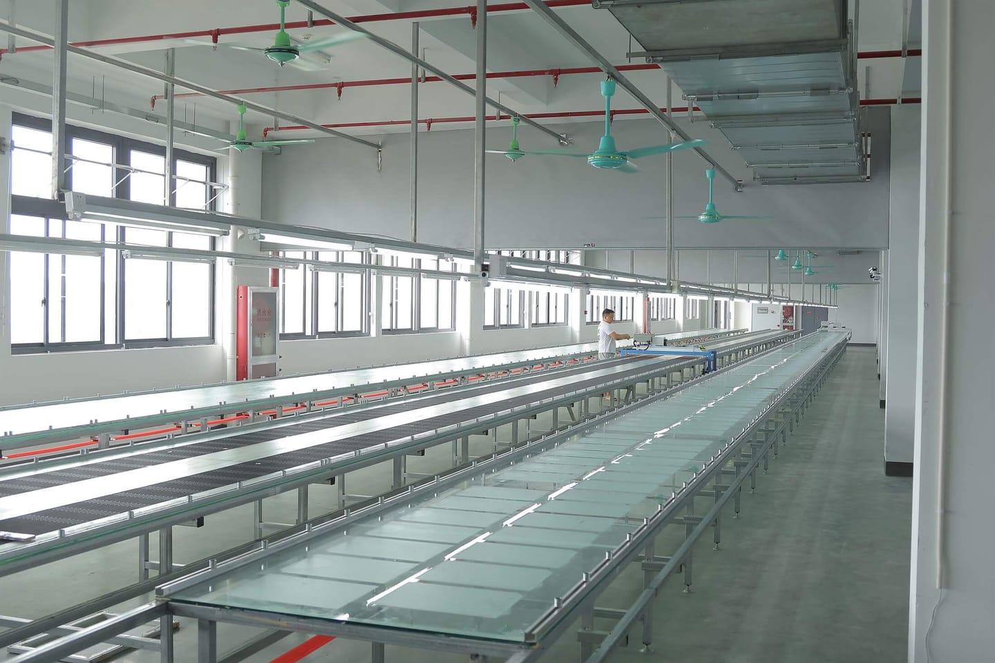 Bright heat transfer production floor with clean workstations and factory equipment